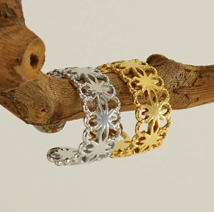 Macro detail of hollow star pattern rings in gold and silver on a wooden branch