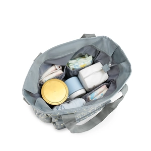 Top view of large gray diaper bag interior showing multi-compartment storage space