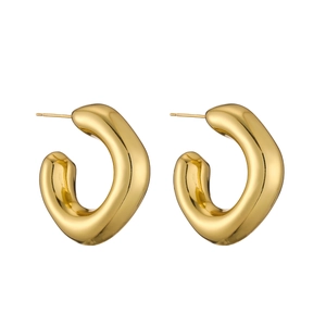 Detail of chunky gold C-shaped hoop earrings with a polished irregular geometric finish