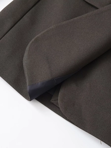 Detailed macro view of dark grey slim fit blazer with rounded edges and black lining