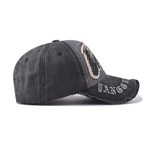 Close-up of vintage washed denim baseball cap with distressed brim and embroidery details
