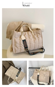 Detail of khaki quilted tote bag with wide geometric woven shoulder strap and matte nylon