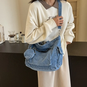 Retro blue denim messenger tote bag with round coin purse and wide strap on model
