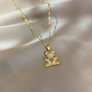 Macro detail of teddy bear pendant with red heart gemstone and micro-paved zircons