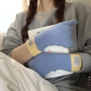 Close-up of blue and yellow knit touchscreen gloves featuring high-quality warm fabric