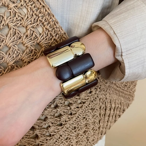 Macro shot of chunky vintage acrylic and gold metal geometric block stretch bracelet