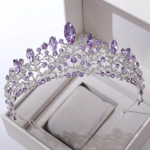 Macro detail of luxury bridal crown with purple crystals and rhinestones in gift box