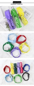 Detail of colorful paisley knot headbands in red, blue, and purple on a soft white fur backdrop