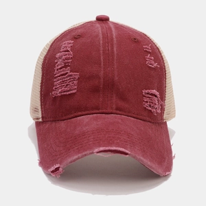 Macro detail of vintage distressed trucker hat with mesh back and torn fabric