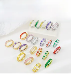 Macro detail of colorful triangle-cut zircon rings in gold and silver plated finishes