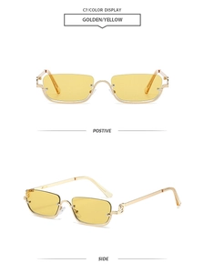 Detail view of square rimless sunglasses with gold metal frame and yellow lenses