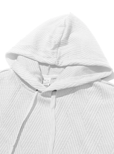 Detailed close-up of white hooded vest showing herringbone texture and neckline fabric
