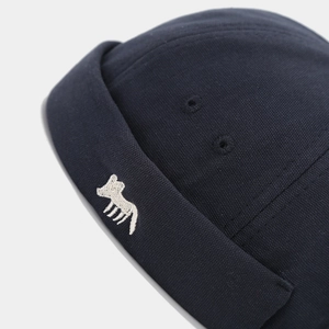 Close-up of the fox embroidery and durable canvas texture on a dark navy sailor cap