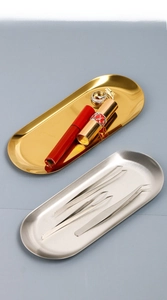 Macro shot of oval stainless steel trays for jewelry and cosmetic organization