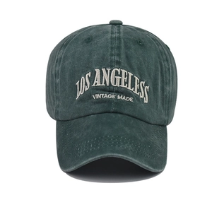 Close-up of vintage dark green baseball cap with white Los Angeles embroidery detail