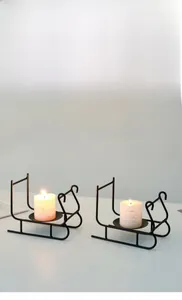 Detail of minimalist black metal sled candle holder for romantic dining table decor