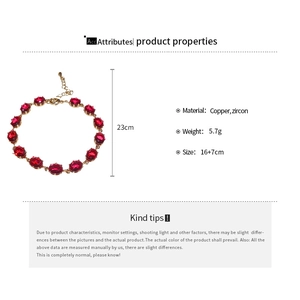 Detailed view of gold copper bracelet with red oval zircons and length specifications