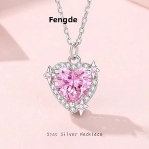 Close-up of S925 silver necklace with pink heart zircon and star details on a pink background