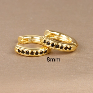 Macro shot of gold hoop earrings with black cubic zirconia and 8mm size marking