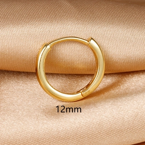 Detail view of 12mm gold hoop earrings with polished finish on champagne silk background