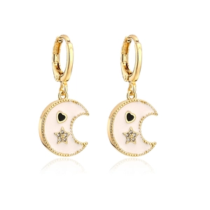 Detail of gold moon earrings with white enamel coating, star zircon, and black heart detail