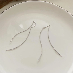 Minimalist S925 sterling silver wave long line earrings on white ceramic tray