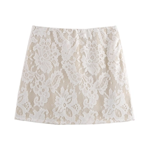 Detailed view of the intricate floral white lace fabric and beige lining on the mini skirt