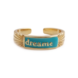 Detailed macro view of gold-plated copper ring with blue enamel and dreame engraving