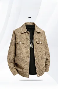 Macro shot of khaki men's jacket featuring brown tropical leaf print and chest pockets