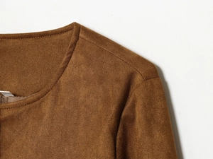 Detailed close-up of the round neckline and suede texture on a brown cropped jacket