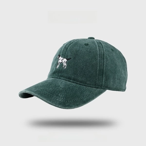 Close-up of fine dog embroidery on a vintage washed dark teal cotton baseball cap