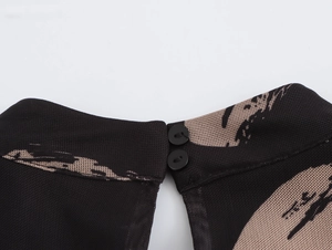 Close-up of the high neck back with two black round buttons on mesh brush print dress
