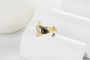 Detail of adjustable gold shark ring featuring vintage black enamel craftsmanship