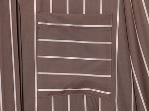 Detailed view of the pocket stitching and brown vertical stripes on the cotton shirt