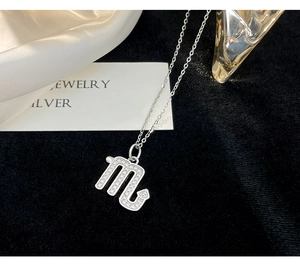 Macro detail of silver Scorpio zodiac pendant with sparkling zircon on high-quality chain