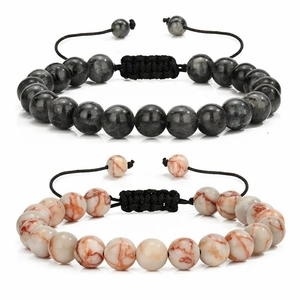 Detail of hand-woven 8mm natural stone bracelets with black wax cord and adjustable knots