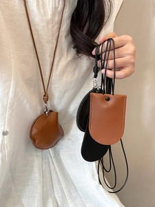 Detailed view of leather magnetic eyeglass holders in black and brown finishes