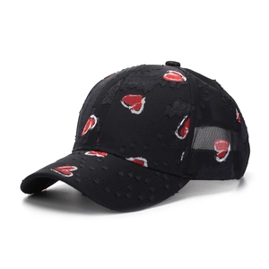 Close-up of heart print baseball cap featuring vintage distressed fabric and ripped details