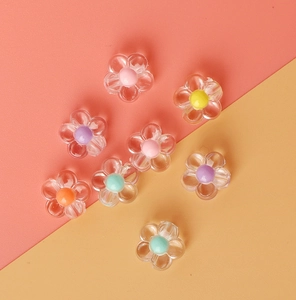 Macro detail of acrylic daisy beads with transparent petals and colorful centers for DIY