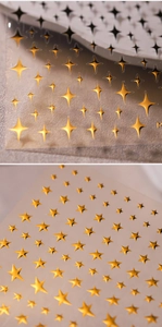 Macro shot of 3D metallic gold star nail art stickers with embossed star patterns