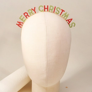 Close-up of Merry Christmas metal headband with festive red and green rhinestones