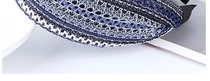Close-up of wavy woven fabric texture and black ribbed trim on a wide headband