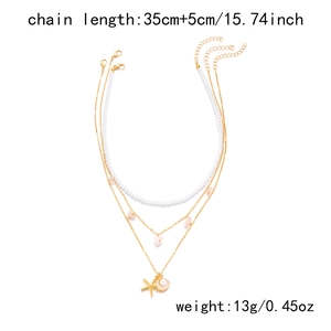Detail view of layered starfish necklace with shell charms and length specifications