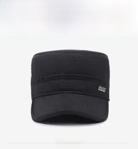 Front view detail of a thick black winter flat cap with metallic JEANS logo decoration
