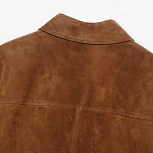 Back view of brown faux suede jacket featuring detailed shoulder stitching and soft texture