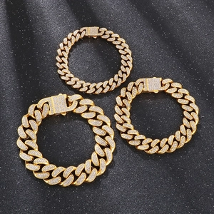 Three widths of golden iced out Cuban link bracelets with sparkling rhinestones on black