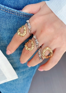 Detail of 18k gold and silver spiral rings with unique irregular pleated textures