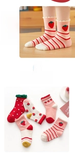 Detail of baby girls' cotton socks with strawberry embroidery, lace trim, and dot patterns