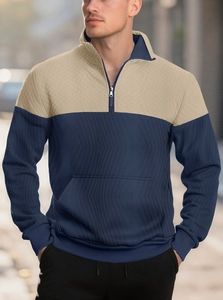 Detail of navy ribbed knit and beige quilted diamond texture on men's polo shirt