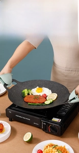 Macro detail of binaural Korean grill pan with non-stick stone coating on gas stove